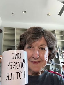 Christine holding cup with caption "One Degree Hotter"