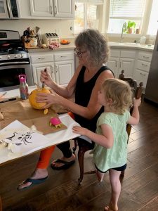 Patty with granddaughter carving pumpkin