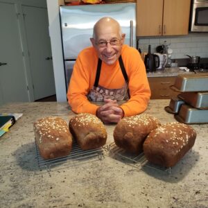 Matt baking bread for Community Loaves non-profit organization