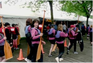 Younger Charlotte holding a paddle 