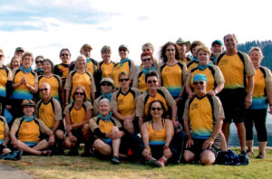 Charlotte with dragon boat paddlers