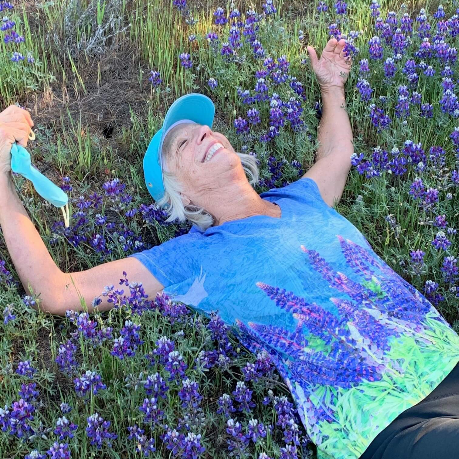 Rita enjoying flowers on a hike