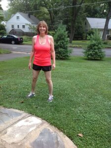 Pat in front yard in running clothes